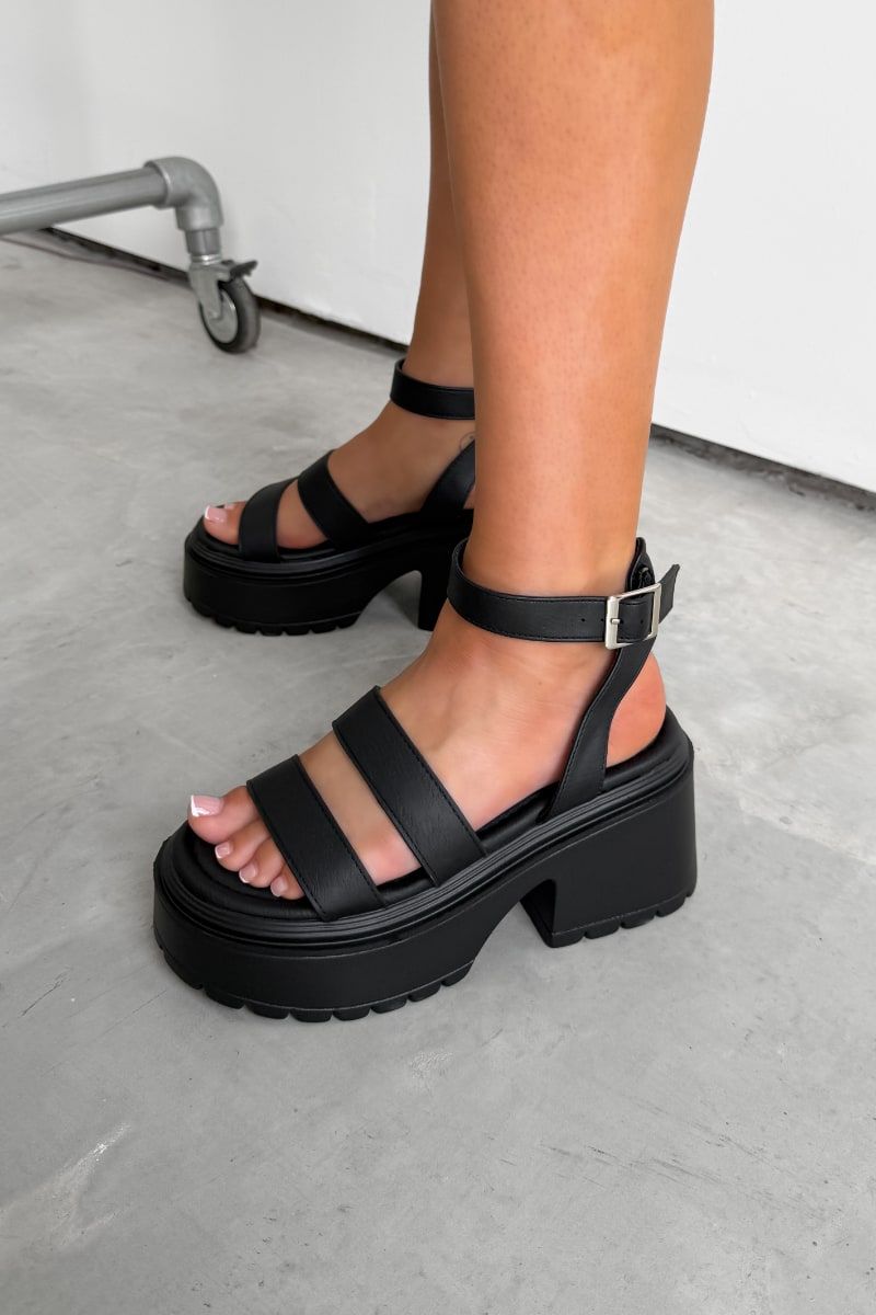 Black platform sandals worn on a neutral background. CIARA Chunky Platform Sandals - Black - 3
