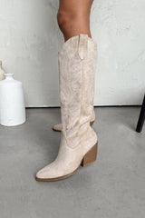Beige knee-high boots on a neutral background
