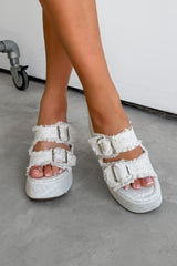 White platform sandals with frayed edges worn by a person on a concrete floor. DEMI Woven Buckle Wedge Sandals - Beige