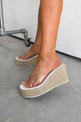 Person wearing beige platform sandals on a concrete floor. SOFIA Espadrille Wedge Perspex Sandals - White - 1