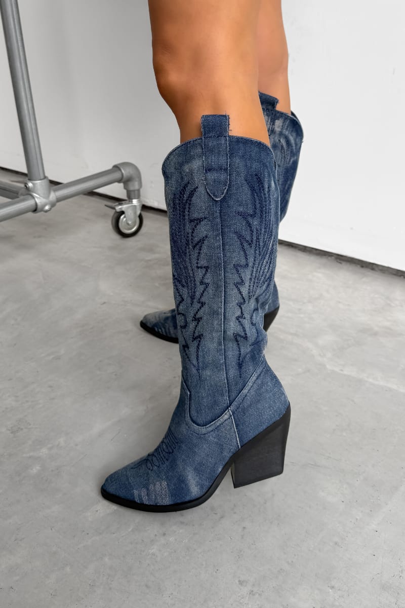 Blue cowboy boots worn by a person on a white background. TENNESSEE Knee High Cowboy Western Boots - Dark Denim - 2